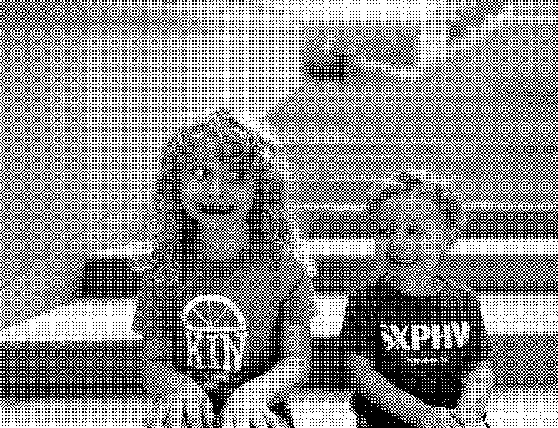 Two kids making faces on the stairs.