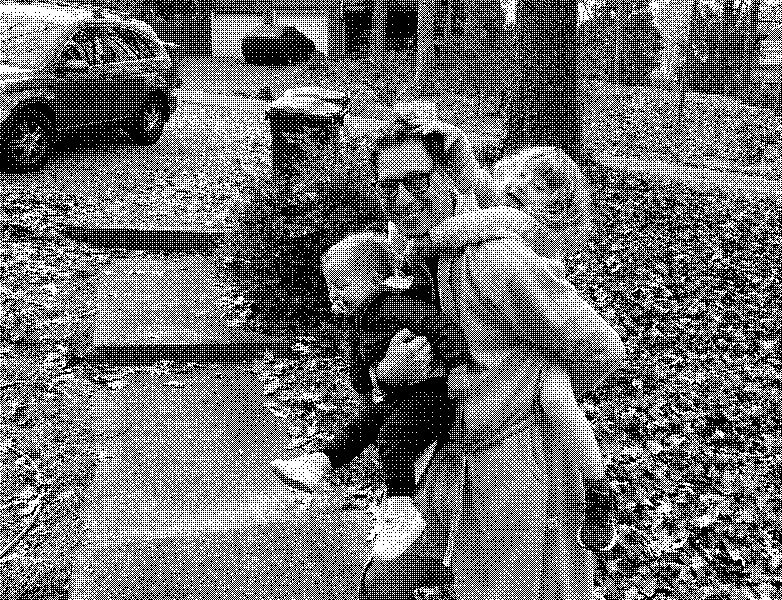 Dad in a gray robe laughing as he hauls two giggling kids through a leaf-covered yard.