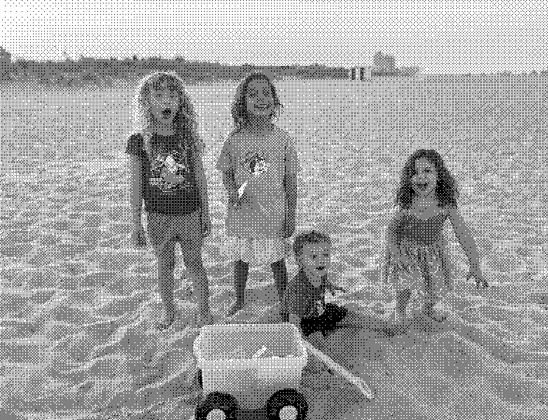 Four kids and a wagon full of sand toys at sunset on the beach.