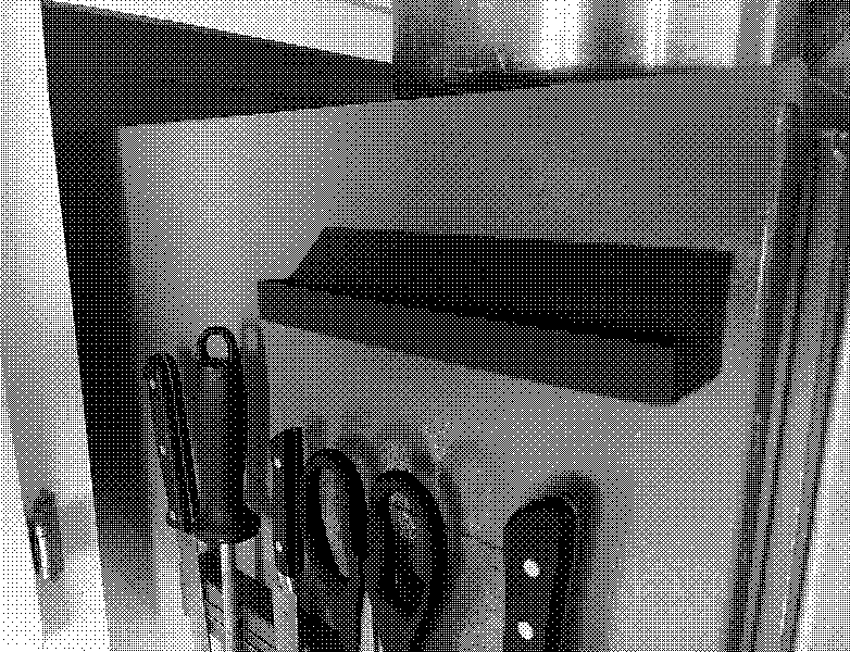 A refrigerator with a 3D printed shelf above a strip of knives.